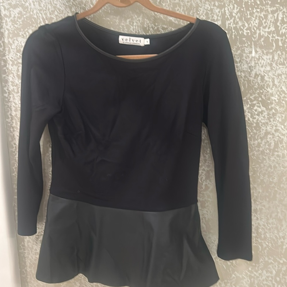 Fitted upper portion, ￼ ￼flare bottom of shirt with leather bottom